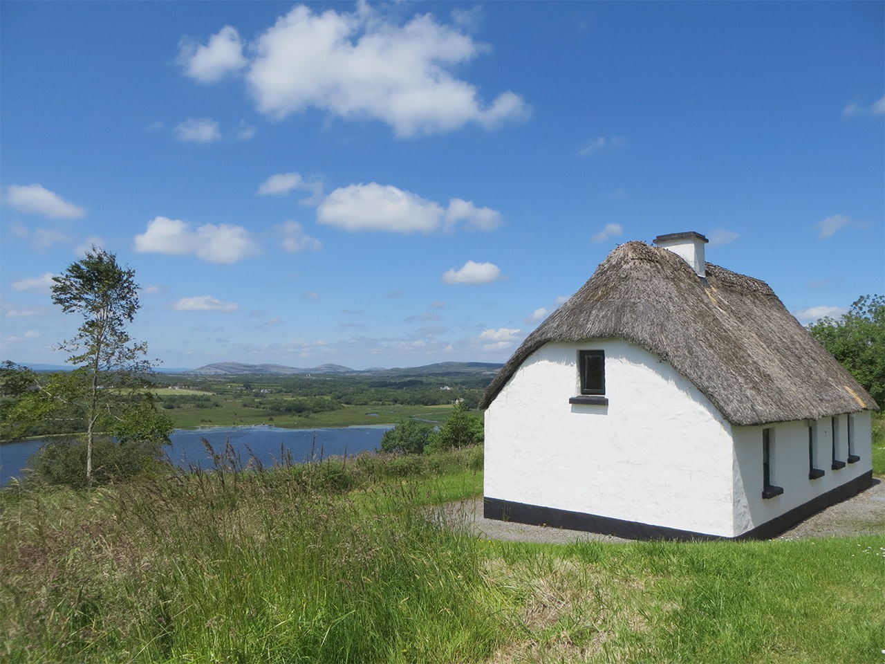 Traditional Irish thatched cottage in the countryside, representing handmade craftsmanship